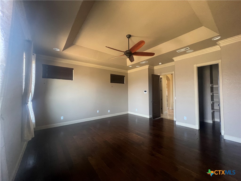 523 Messer Ranch Road Belton, TX 76513 - Photo 19 of 40 a view of an empty room with wooden floor and a ceiling fan