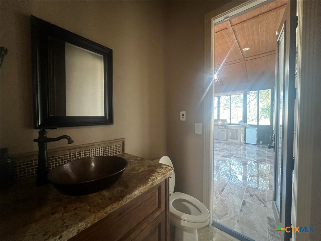 523 Messer Ranch Road Belton, TX 76513 - Photo 25 of 40 a bathroom with a toilet sink and mirror
