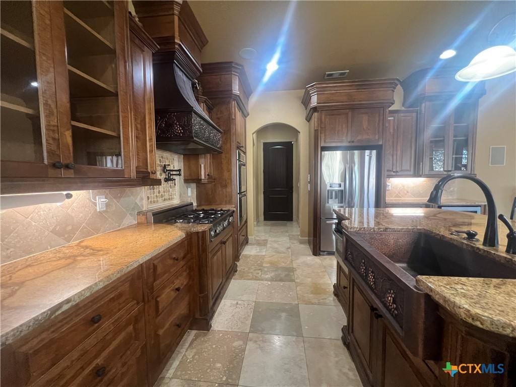 523 Messer Ranch Road Belton, TX 76513 - Photo 10 of 40 a kitchen with stainless steel appliances granite countertop a sink and a stove