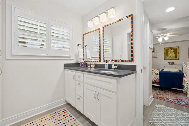 a living room with furniture a chandelier and a fireplace