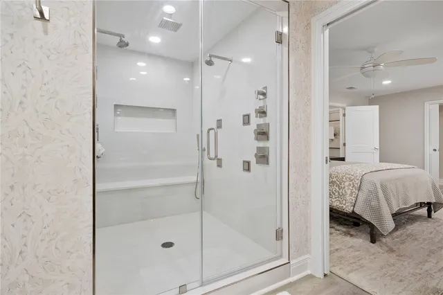 a bedroom with a bed a couch and a dresser next to a window