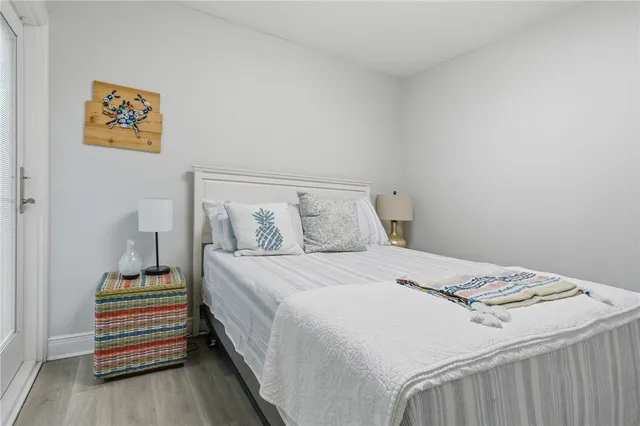 an aerial view of a city with lots of residential buildings and ocean view in back