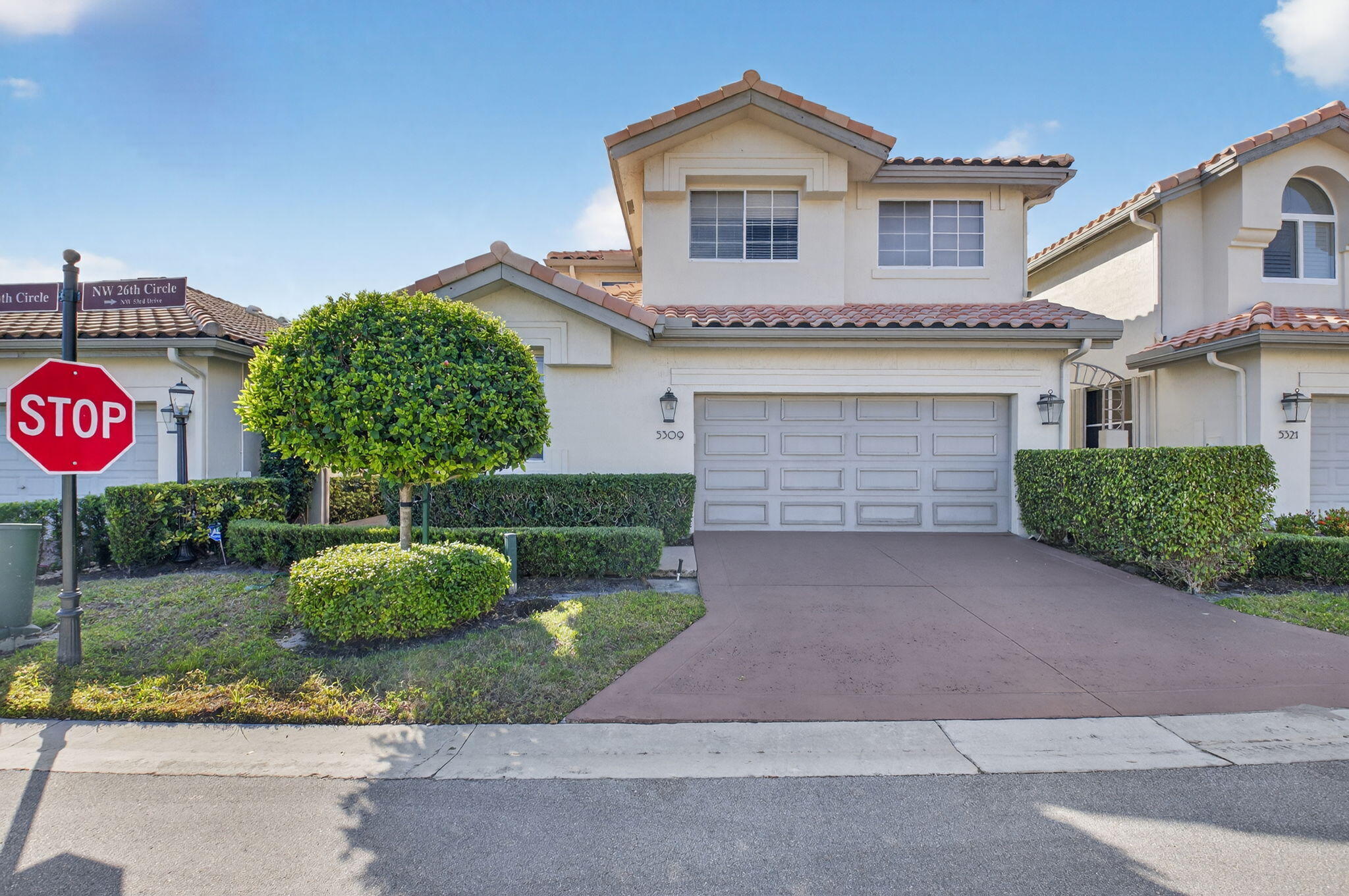 a front view of a house with a yard and garage