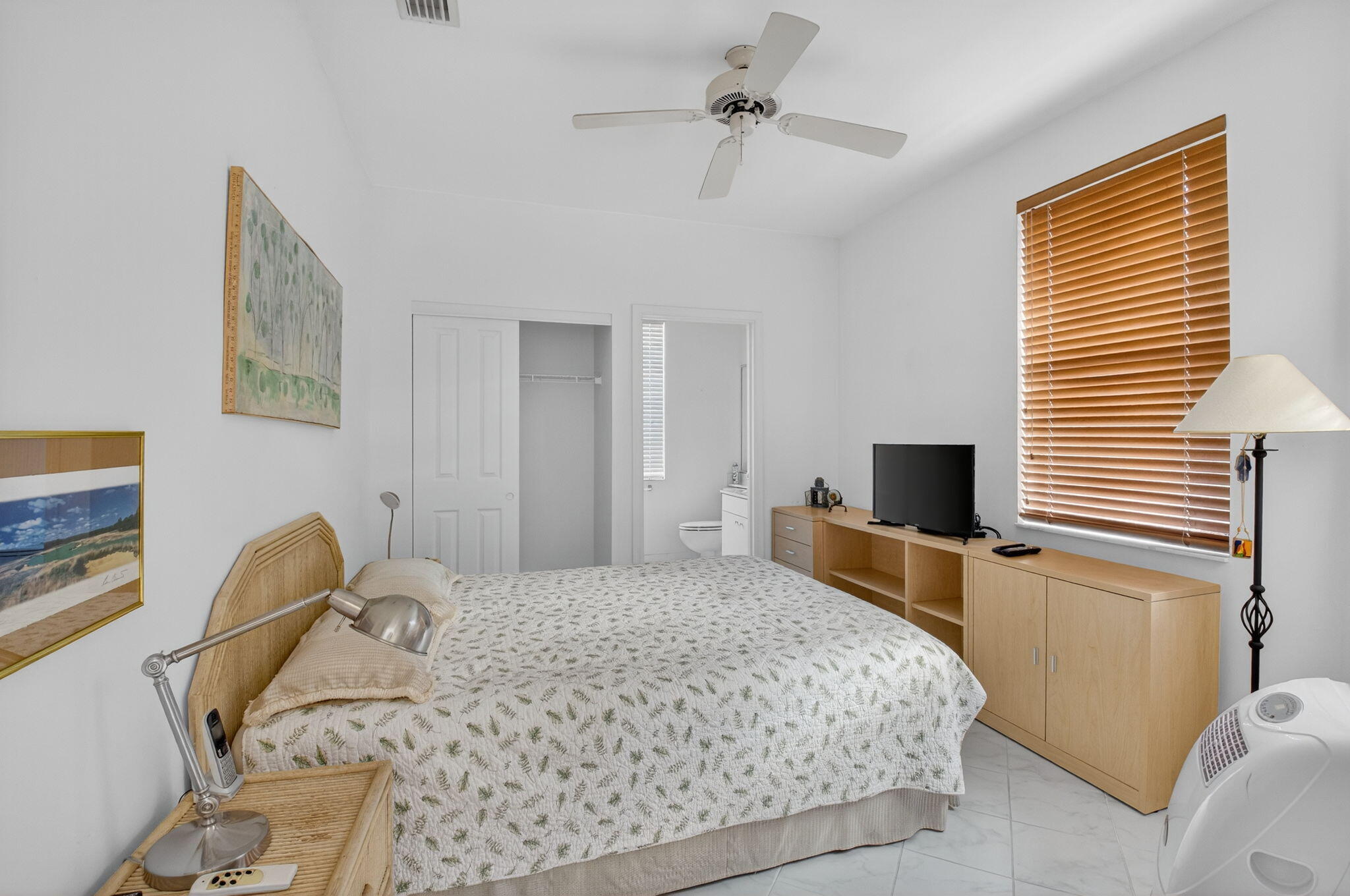 5309 Northwest 26th Circle Boca Raton, FL 33496 - Photo 13 of 37 a bedroom with a bed and a flat screen tv