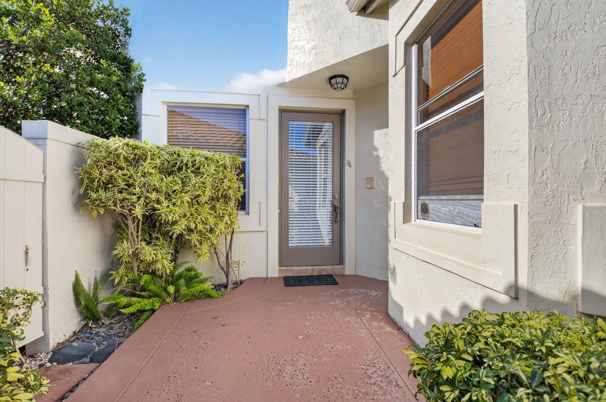 5309 Northwest 26th Circle Boca Raton, FL 33496 - Photo 2 of 37 a front view of a house with a yard