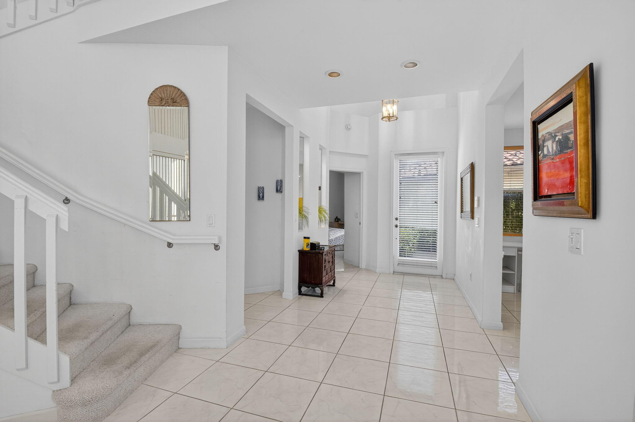 5309 Northwest 26th Circle Boca Raton, FL 33496 - Photo 6 of 37 a view of a hallway with bathroom and front door