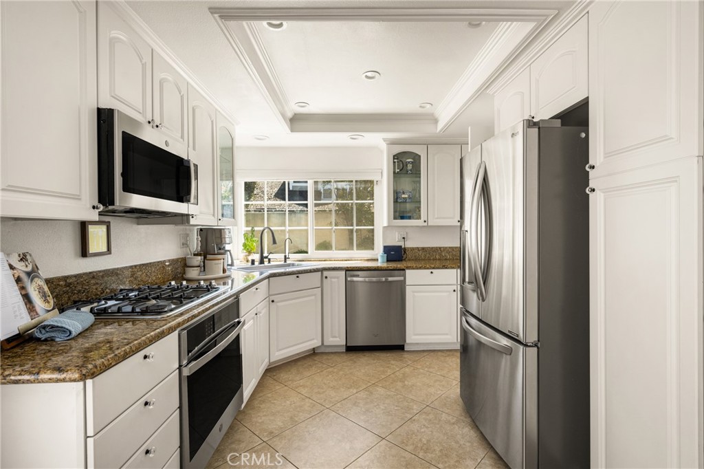 9 Newmeadow Irvine, CA 92614 - Photo 11 of 36 a kitchen with a refrigerator stove and microwave