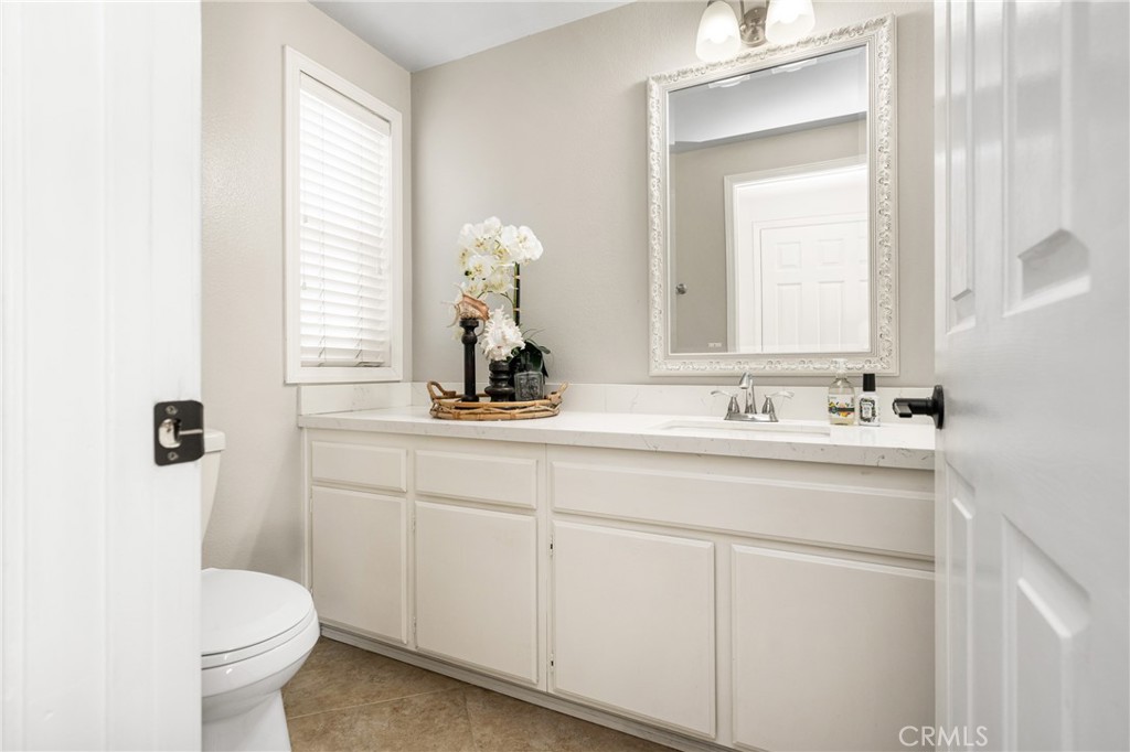 9 Newmeadow Irvine, CA 92614 - Photo 17 of 36 a bathroom with a toilet sink and mirror