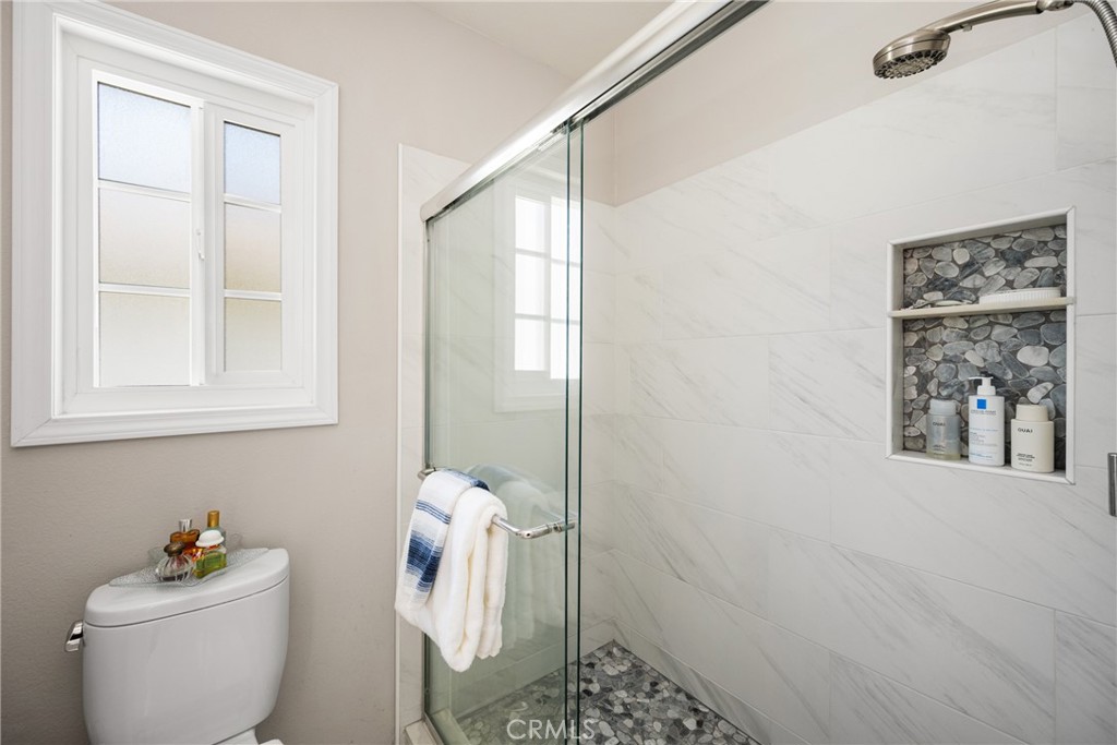 9 Newmeadow Irvine, CA 92614 - Photo 21 of 36 a bathroom with a toilet and a shower curtain