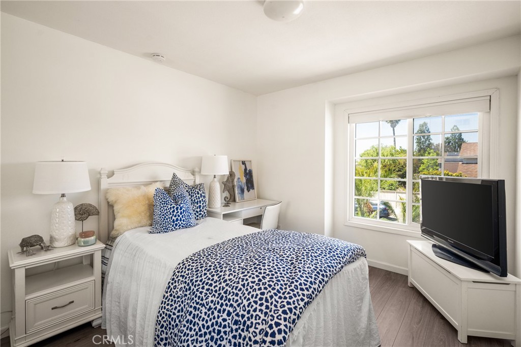 9 Newmeadow Irvine, CA 92614 - Photo 24 of 36 a bedroom with a bed and a flat tv screen on dresser