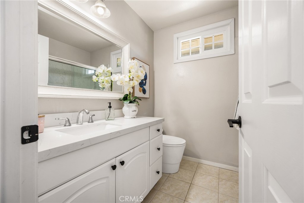 9 Newmeadow Irvine, CA 92614 - Photo 25 of 36 a bathroom with a sink and a mirror