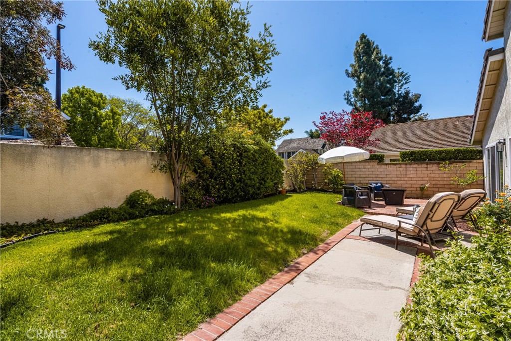 9 Newmeadow Irvine, CA 92614 - Photo 29 of 36 a front view of a house with a garden and a lake view