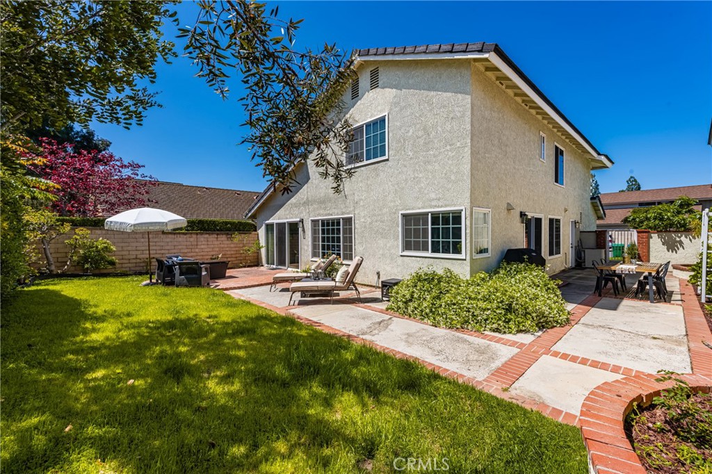 9 Newmeadow Irvine, CA 92614 - Photo 30 of 36 a view of a house with backyard sitting area and garden