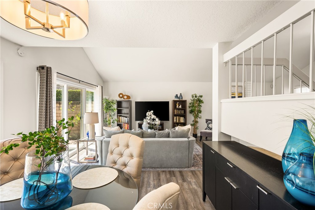 9 Newmeadow Irvine, CA 92614 - Photo 7 of 36 a living room with furniture a flat screen tv and a large window