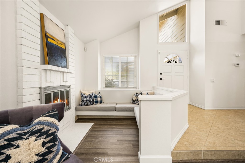 9 Newmeadow Irvine, CA 92614 - Photo 9 of 36 a living room with furniture and a fireplace