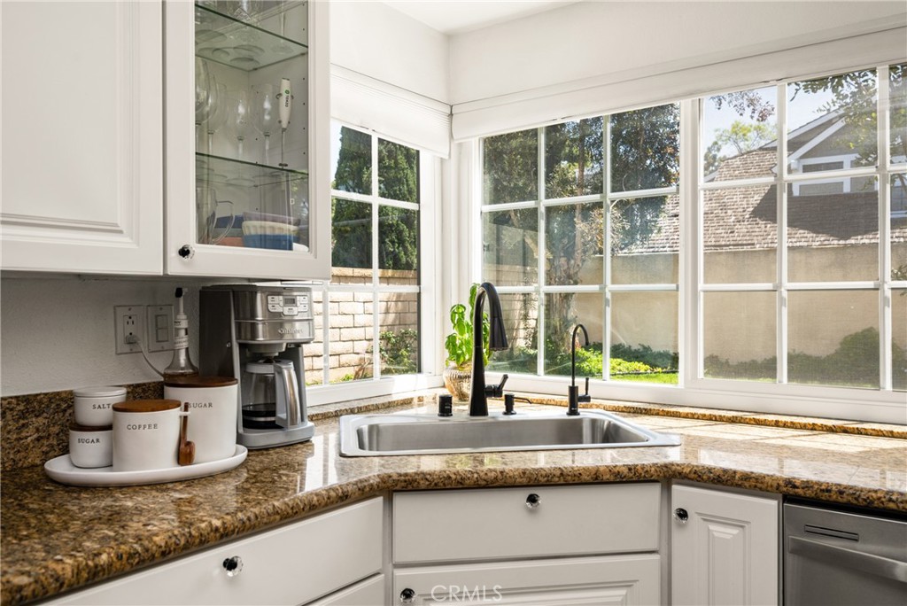 9 Newmeadow Irvine, CA 92614 - Photo 10 of 36 a kitchen with granite countertop a sink and a window