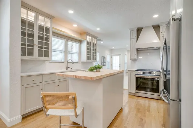 a kitchen with a stove a sink and a refrigerator