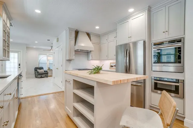 a kitchen with a sink stove and refrigerator
