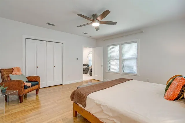 a bedroom with a bed and wooden floor