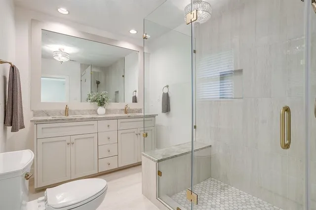a bathroom with a toilet sink and shower
