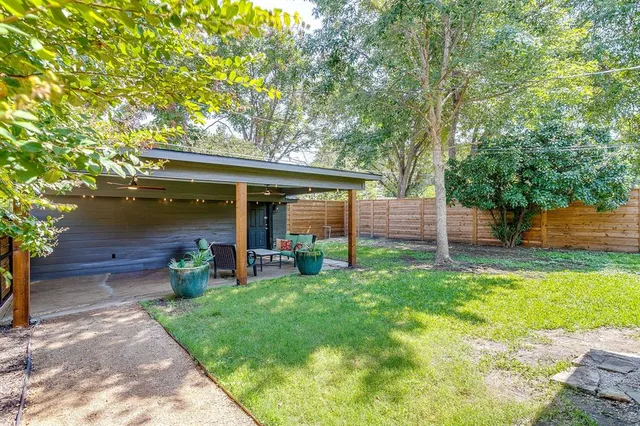 a view of a house with a yard and sitting area