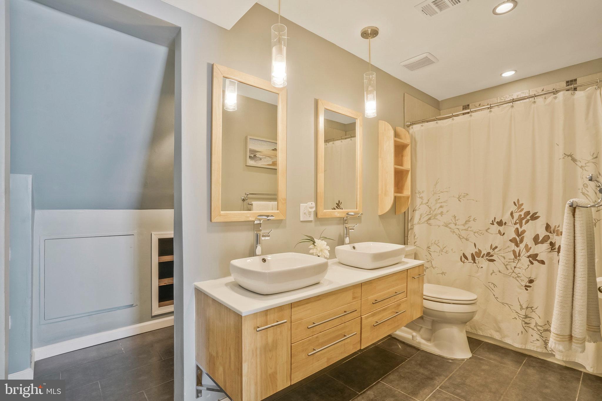 2181 Shirlington Road Arlington, VA 22206 - Photo 27 of 48 a bathroom with a double vanity sink mirror and toilet