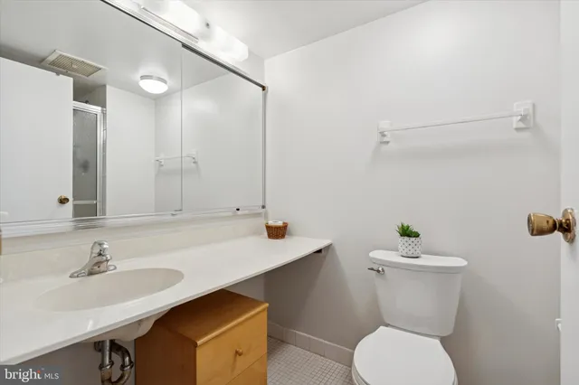 a bathroom with a sink toilet and a mirror