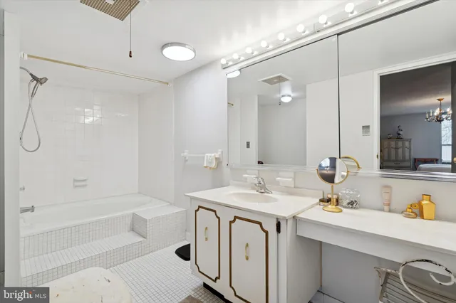 a bathroom with a tub sink and mirror