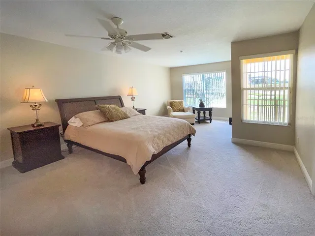 a bedroom with a bed and a lamp