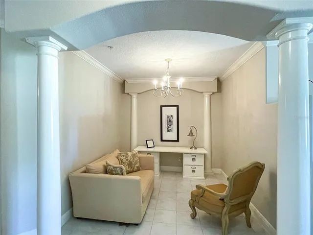 a living room with furniture and a chandelier