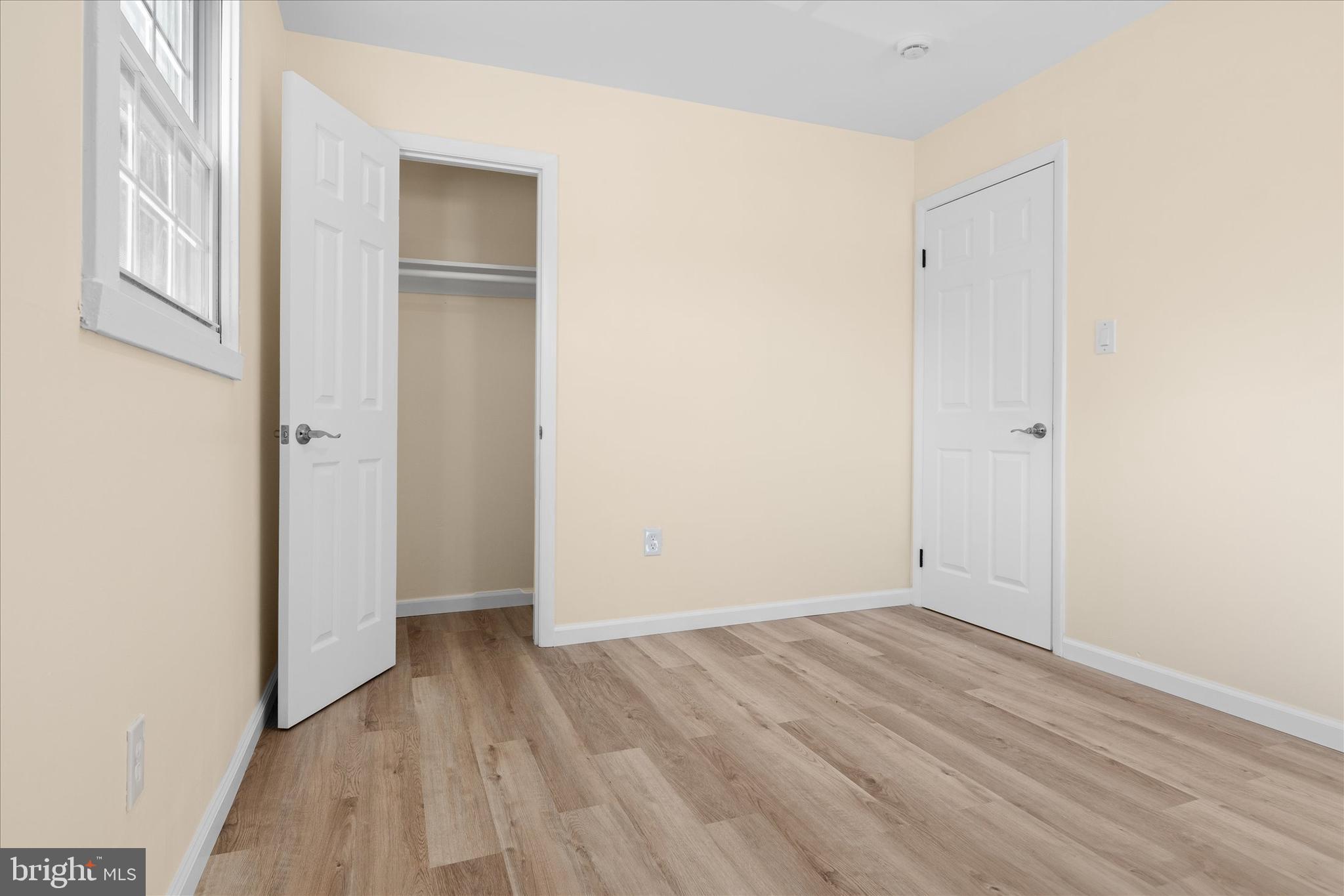 14220 Fallbrook Lane Woodbridge, VA 22193 - Photo 14 of 34 an empty room with wooden floor and windows