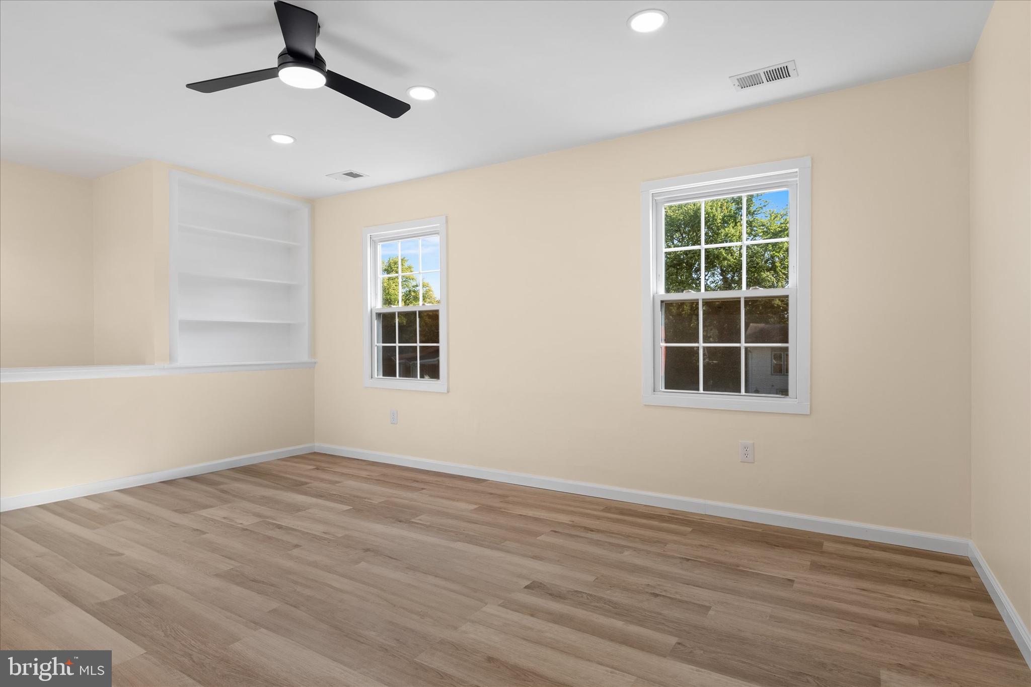 14220 Fallbrook Lane Woodbridge, VA 22193 - Photo 18 of 34 a view of an empty room with a window and wooden floor