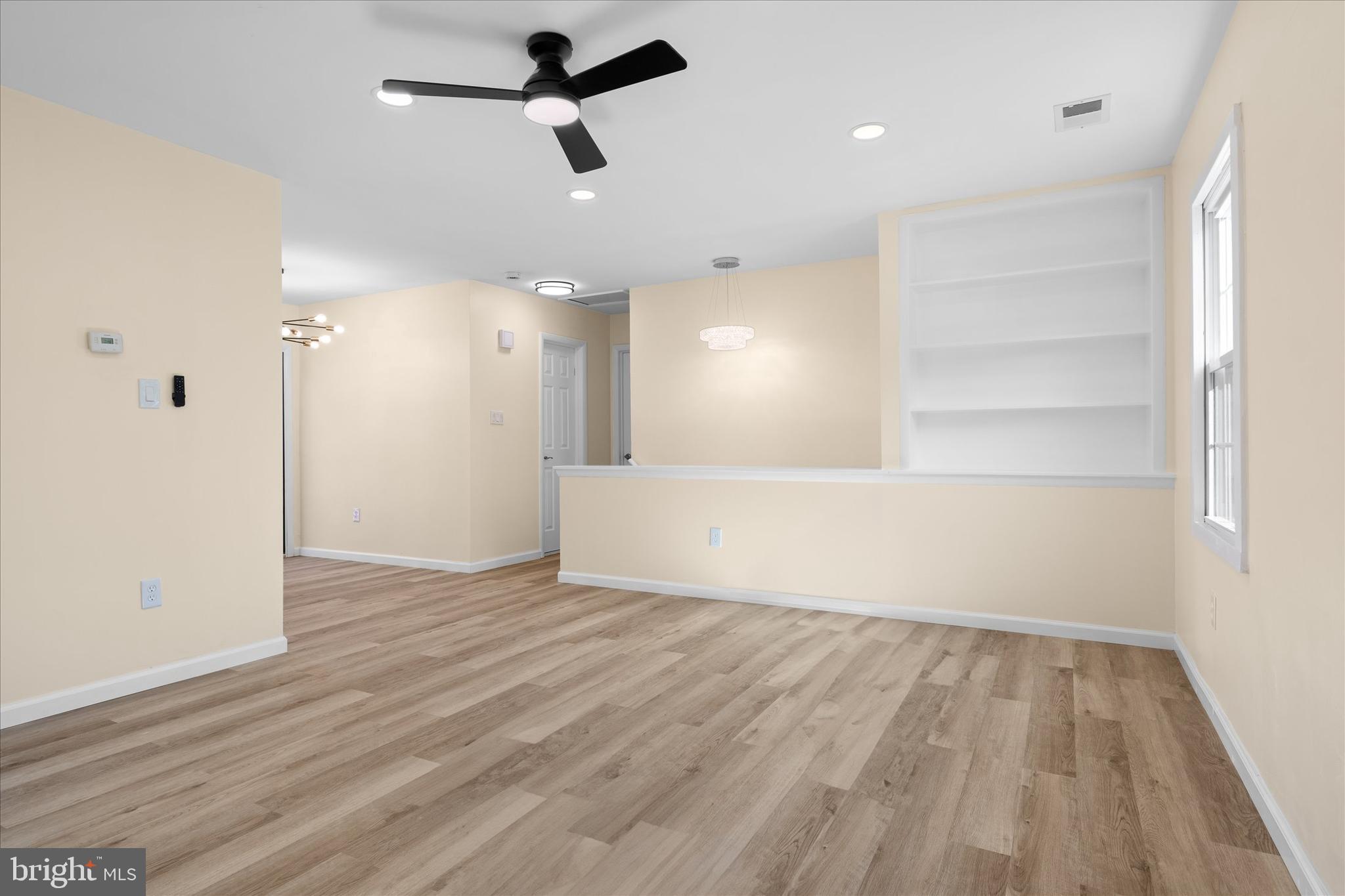 14220 Fallbrook Lane Woodbridge, VA 22193 - Photo 21 of 34 wooden floor in an empty room with a window