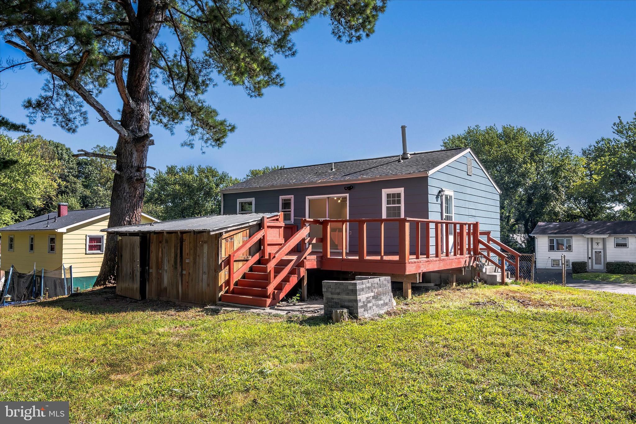 14220 Fallbrook Lane Woodbridge, VA 22193 - Photo 30 of 34 a view of a house with a yard and deck