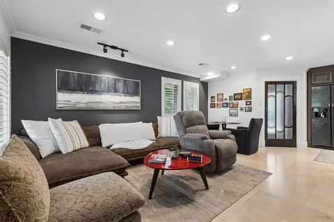 a living room with furniture and kitchen view