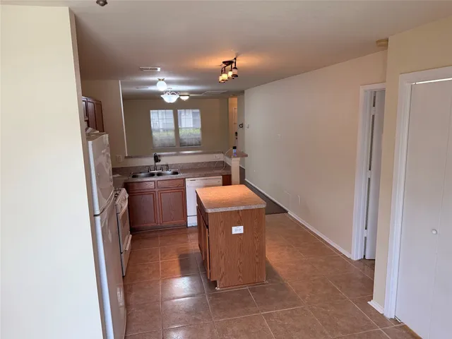 a kitchen with a sink and a stove top oven