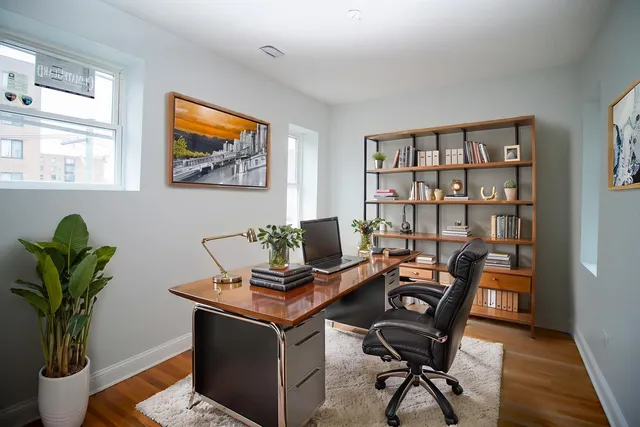 a view of a workspace with a bookshelf
