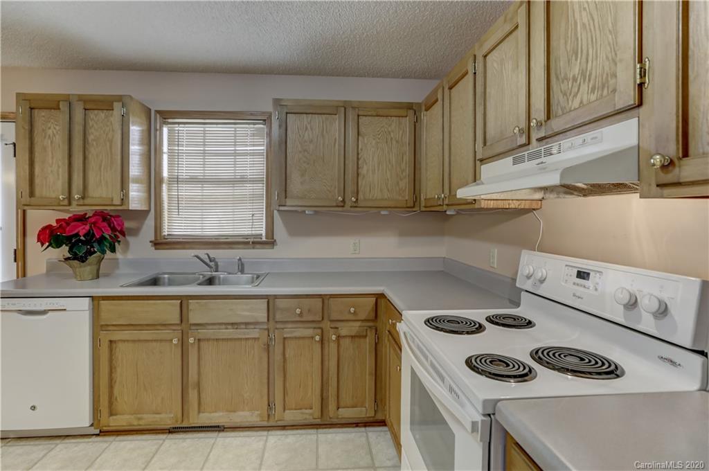 452 Owens Road York, SC 29745 - Photo 22 of 48 a kitchen with a sink a stove and cabinets