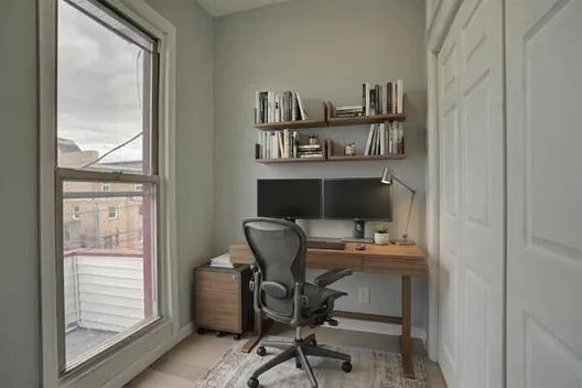 a work room with furniture and a window