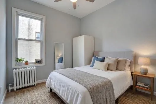 a bedroom with a bed and a window