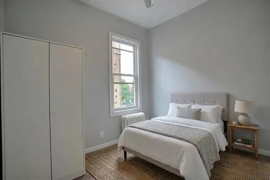 a bedroom with a bed and a window