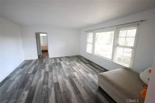 a view of room with window and wooden floor