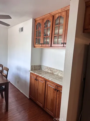 a hallway with granite countertop wooden floors