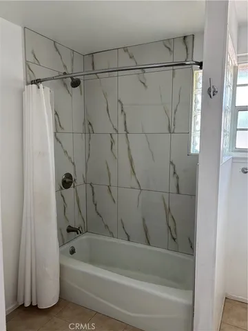 a bathroom with a shower and a bathtub