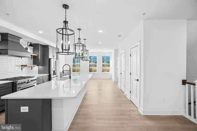 a very nice looking kitchen with granite countertop a sink stainless steel appliances and cabinets