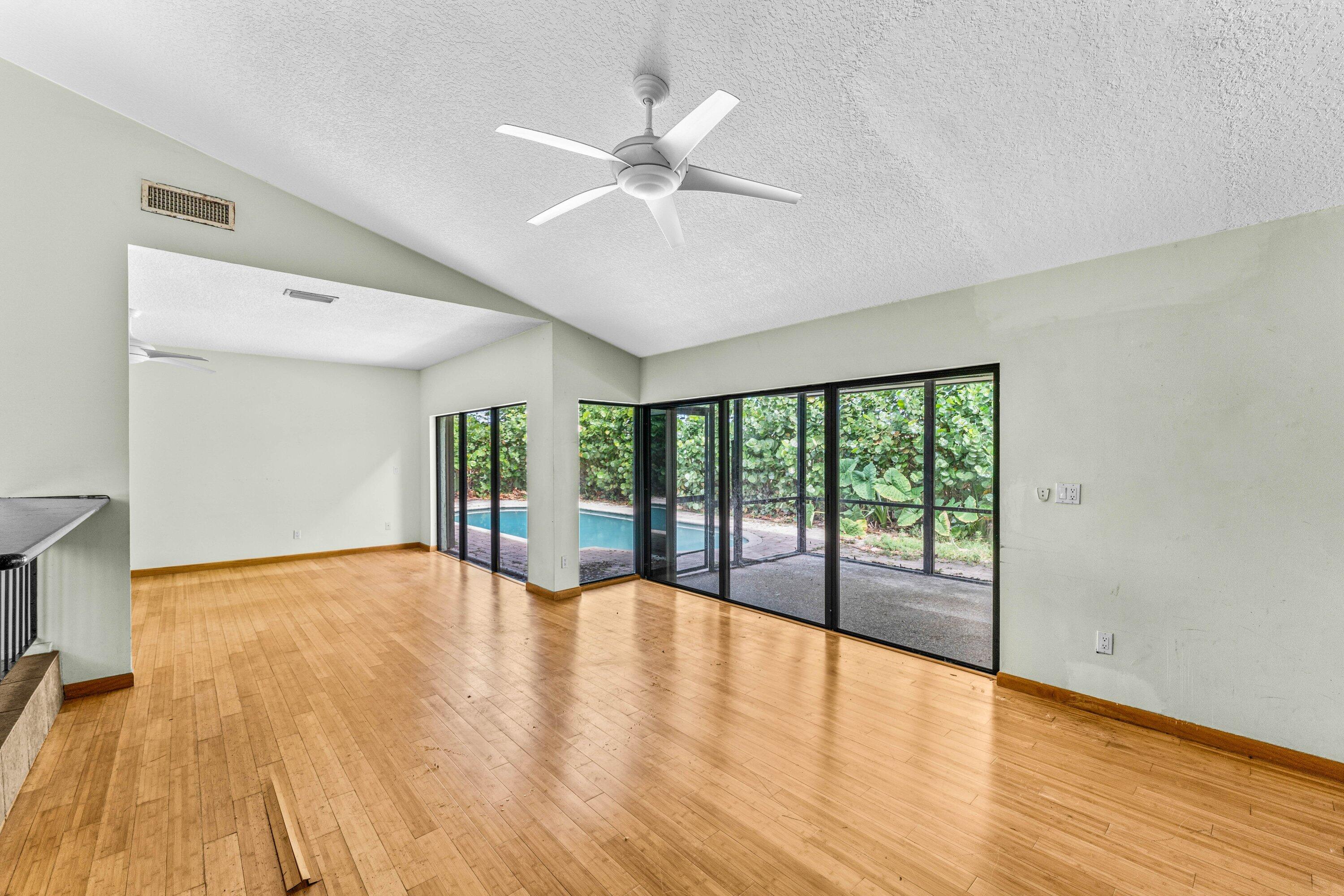 2753 Northwest 34th Street Boca Raton, FL 33434 - Photo 14 of 41 a view of an empty room with wooden floor and a window
