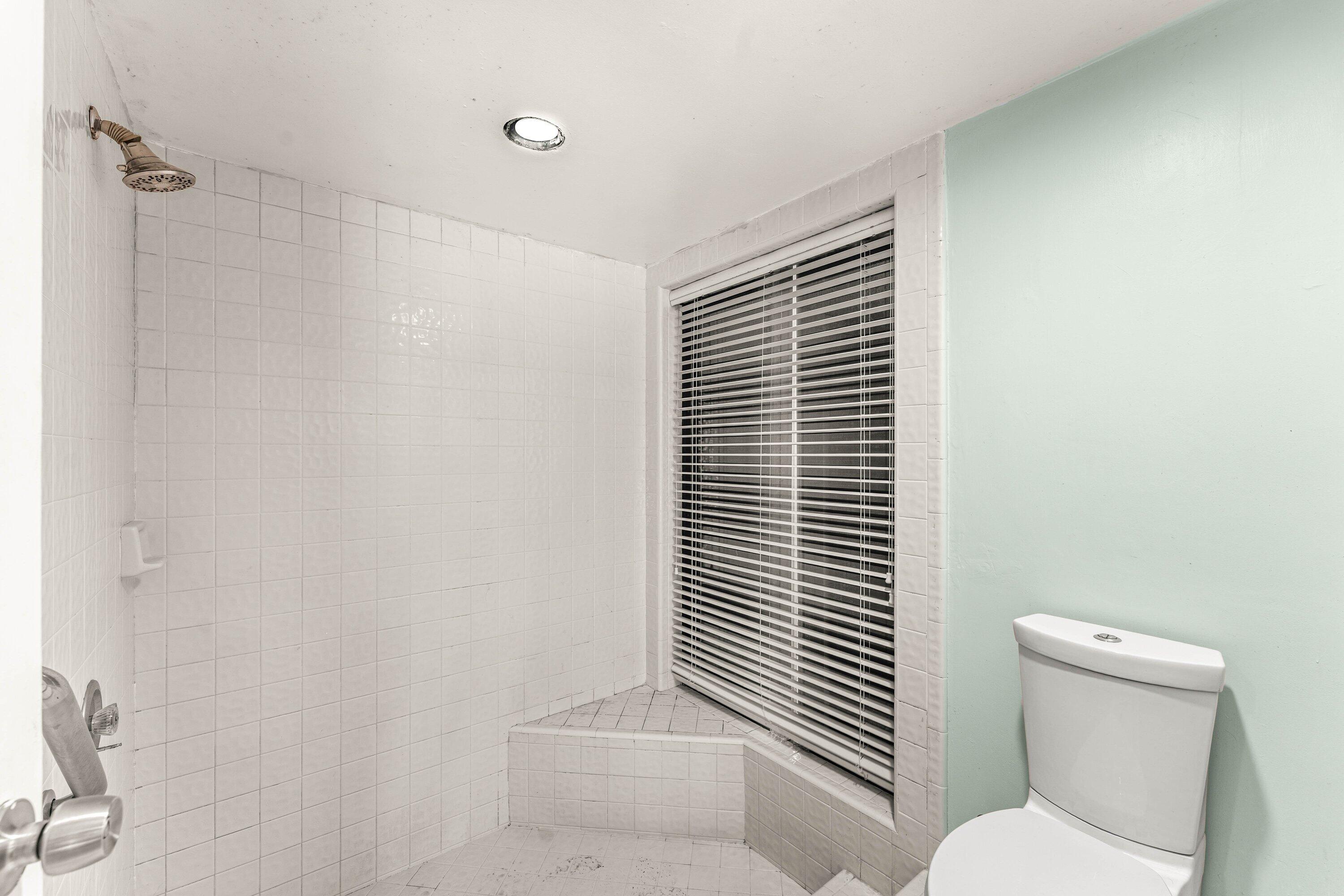 2753 Northwest 34th Street Boca Raton, FL 33434 - Photo 21 of 41 a bathroom with a toilet and shower