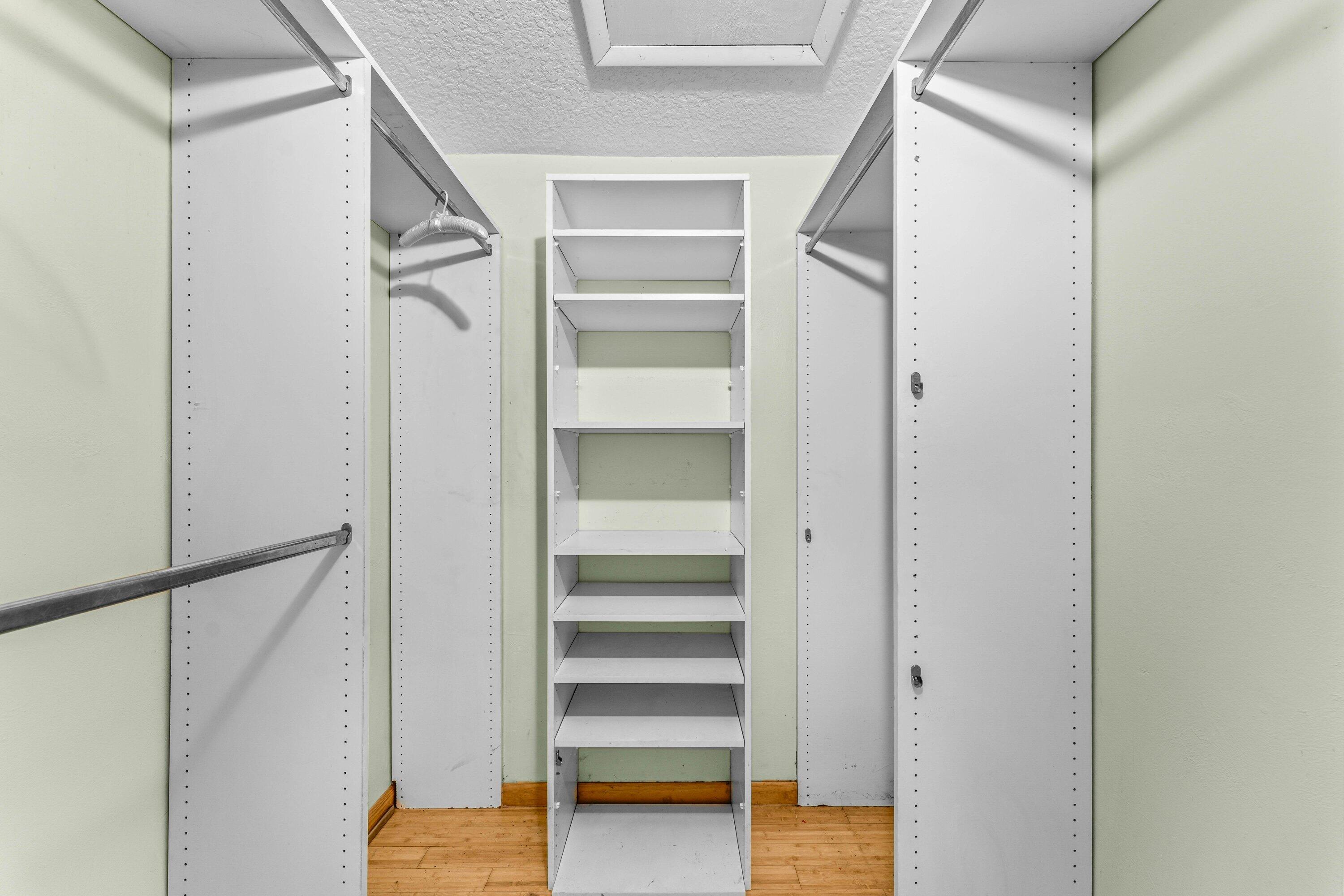 2753 Northwest 34th Street Boca Raton, FL 33434 - Photo 22 of 41 a view of walk in closet with empty racks