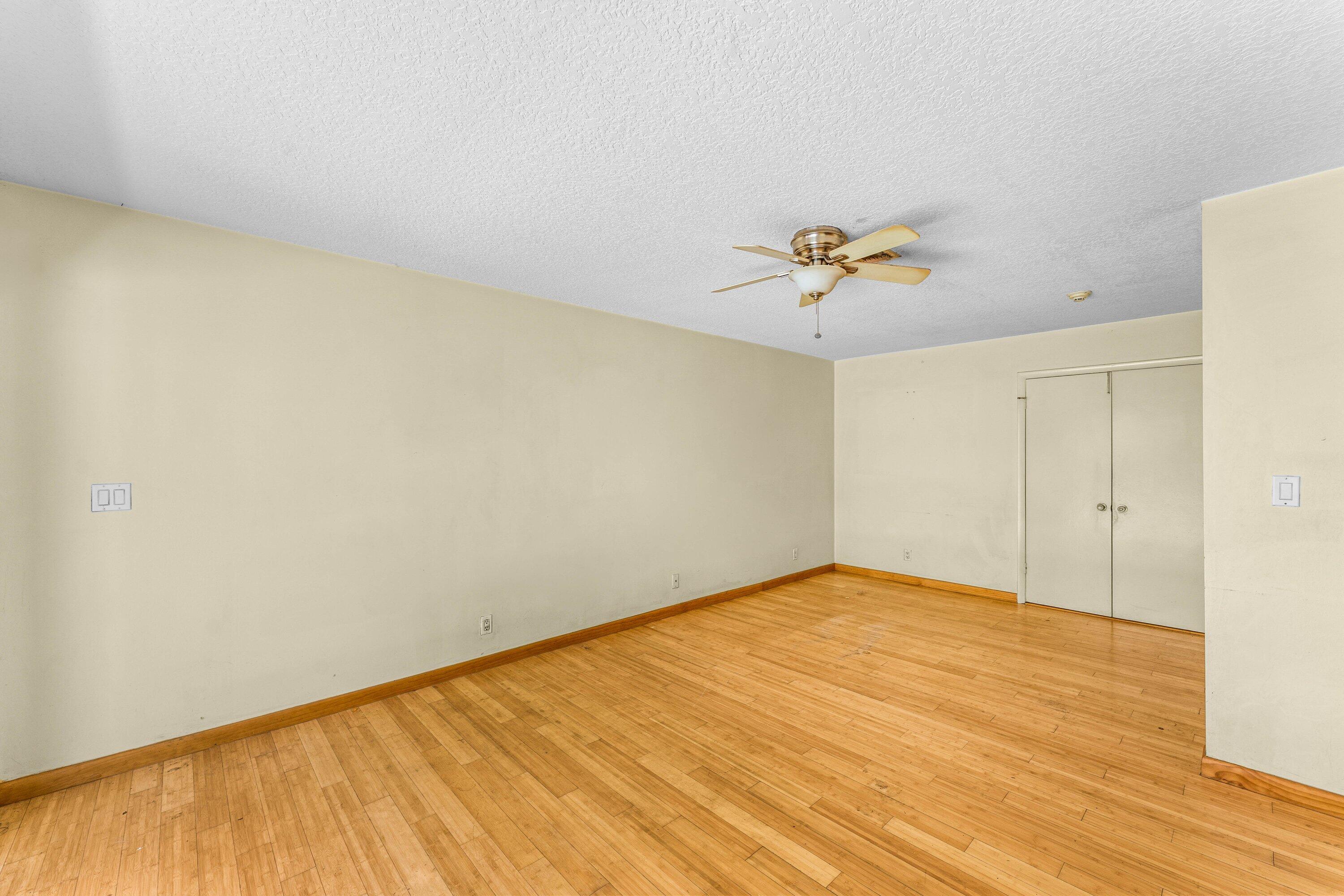 2753 Northwest 34th Street Boca Raton, FL 33434 - Photo 24 of 41 a view of a room with a ceiling fan and wooden floor