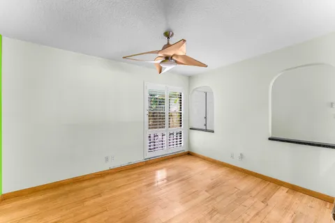 a view of an empty room with a fireplace and a window